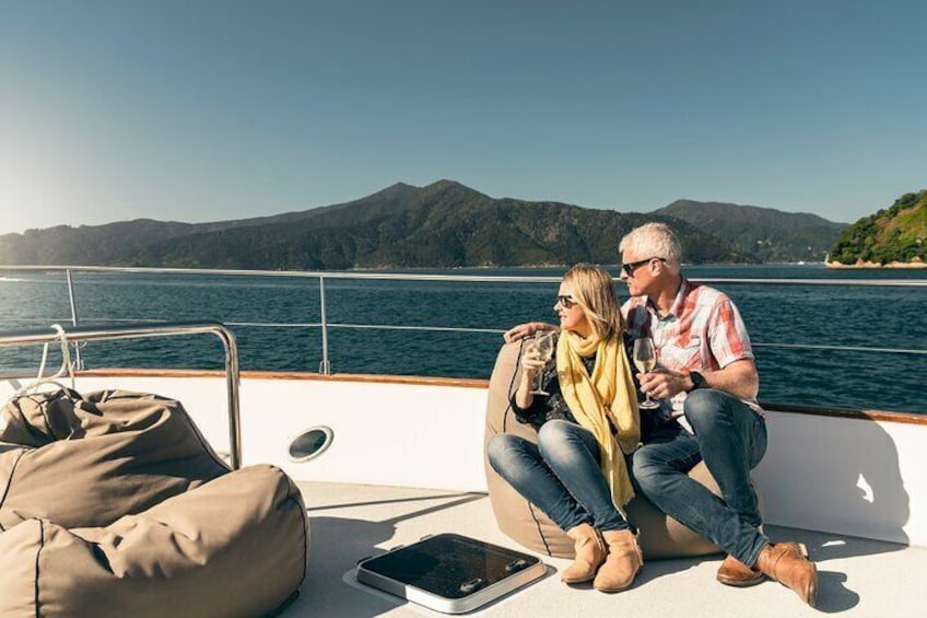 Couple on board boat in Marlborough Sounds with wine