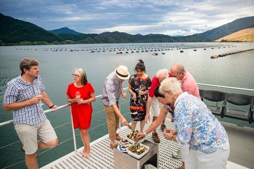 Group on Seafood cruise tasting fresh Greenshell mussels