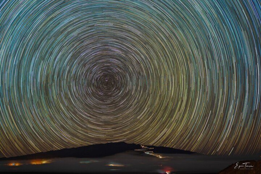 Star Trails over the mountain - This is a stack of 400 photos blended together to show you the rotation of Earth.