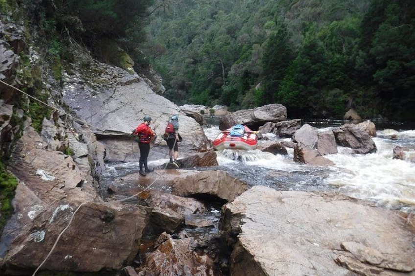 Guides portaging the raft in the King River Gorge