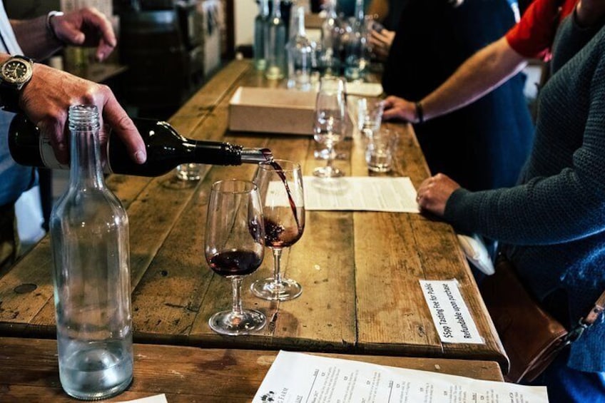 Staff at Yarra Valley's Yering Farm winery serve red wine ready to be sampled by visitors.