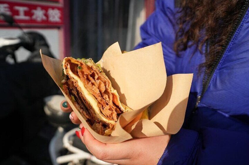 Try jianbing with a twist at this hole-in-the-wall spot, where a classic mung bean wrap meets a cheesy upgrade—blending tradition with tasty innovation.