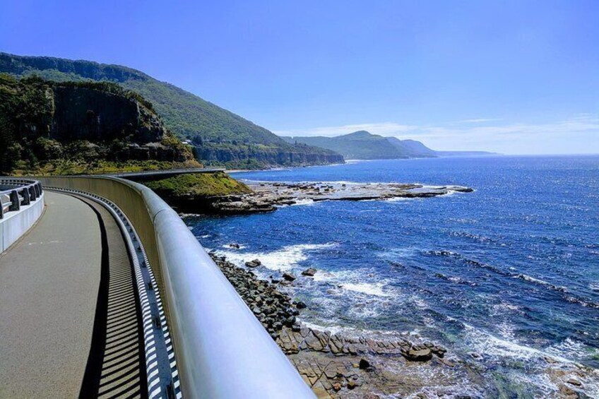 Traverse the Sea Cliff Bridge along the Grand Pacific Drive