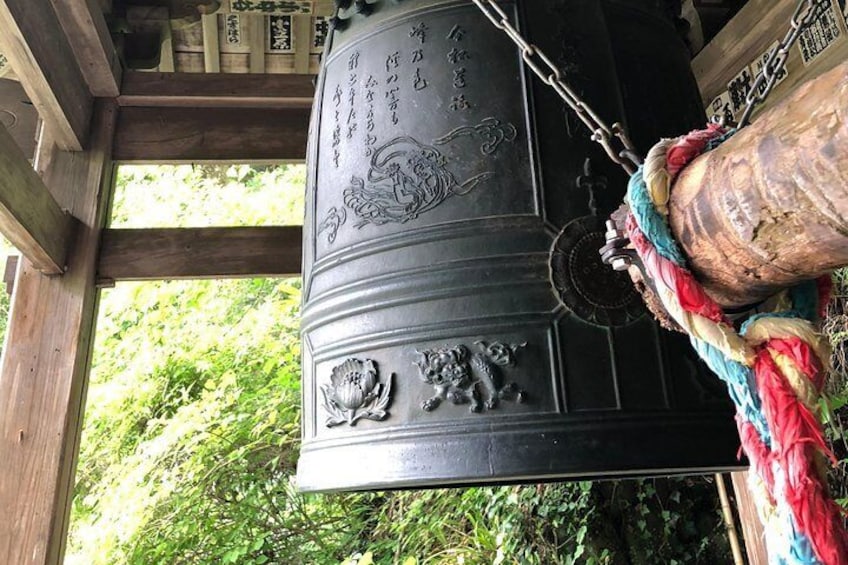 Big bell at a hidden temple in the woods.