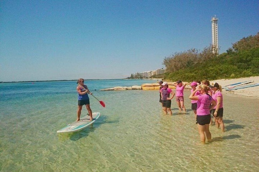 Paddleboard instruction on the crystal clear water