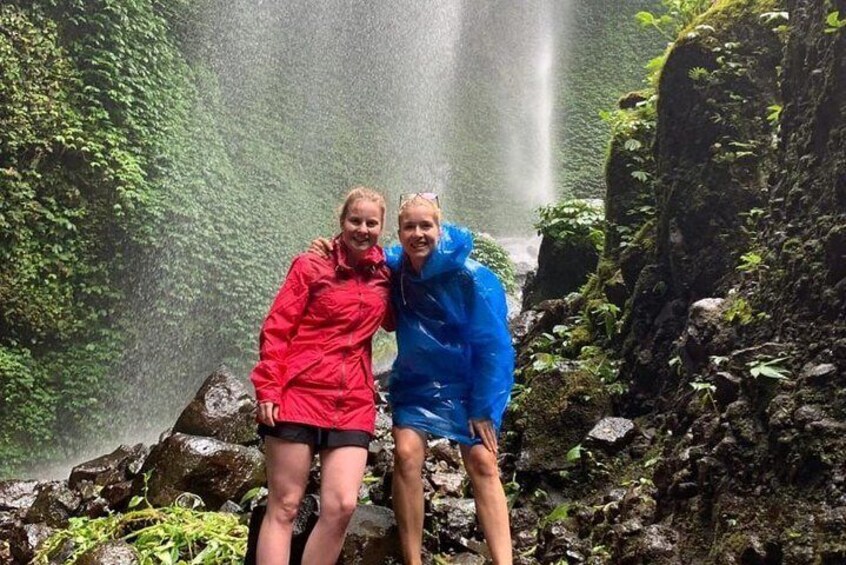 Girls posing at Madakaripura Waterfall