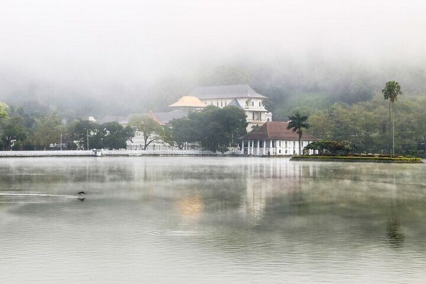 Kandy tooth temple with a lake view in a misty morning