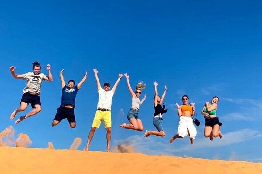 Jumping at the yellow sand dune 