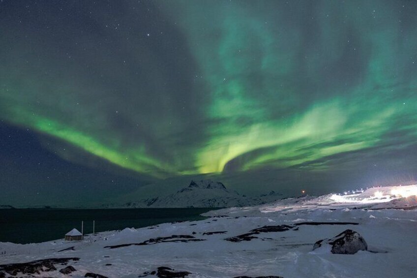 Northern lights over Nuuk icon- Sermitsiaq mountain. Photo By Lasse Kyed