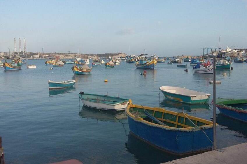 Marsaxlokk,the fishing village at the southern tip of Malta, is alive with fishing boats entering the harbour with their early morning catch, and has a bustling Sunday fish market.