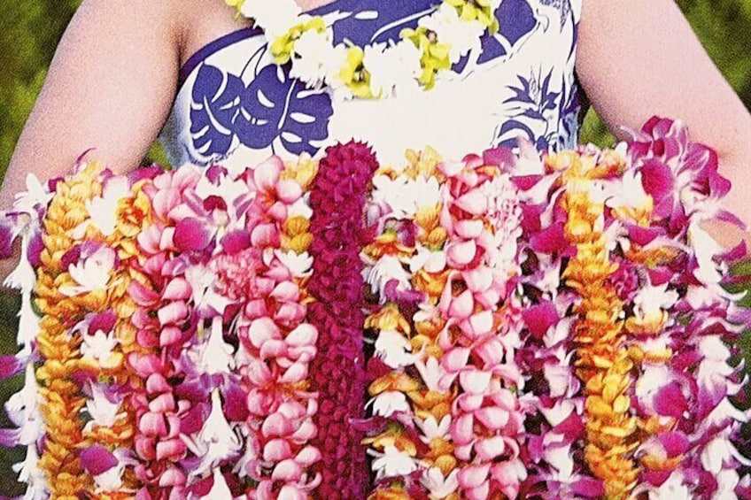 Greeter holding leis