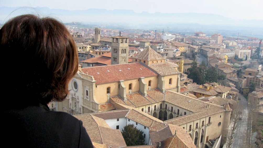 woman looking at building from above in Barcelona