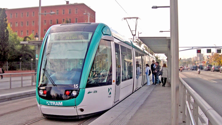 passengers boarding light rail at train station in Barcelona