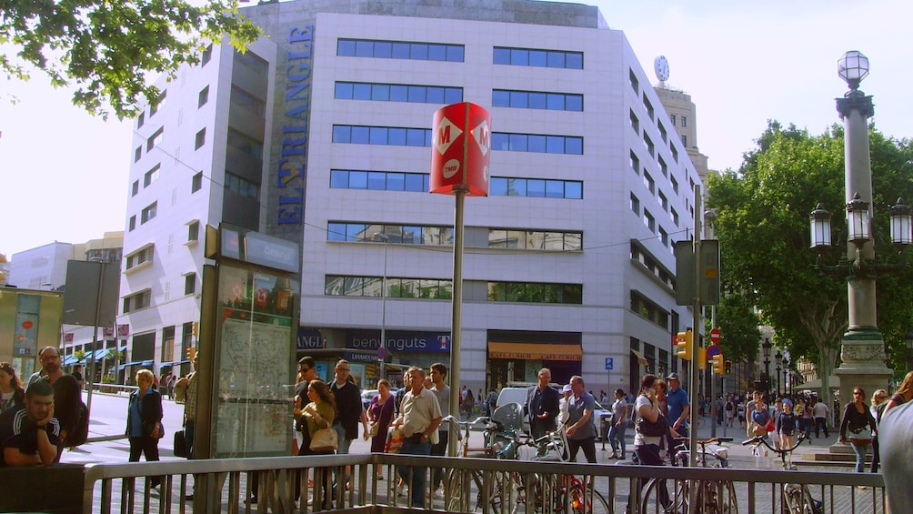 Passengers wait for light rail at train stop in Barcelona