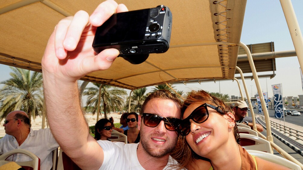 man and woman taking a selfy shot on tour bus in Dubai