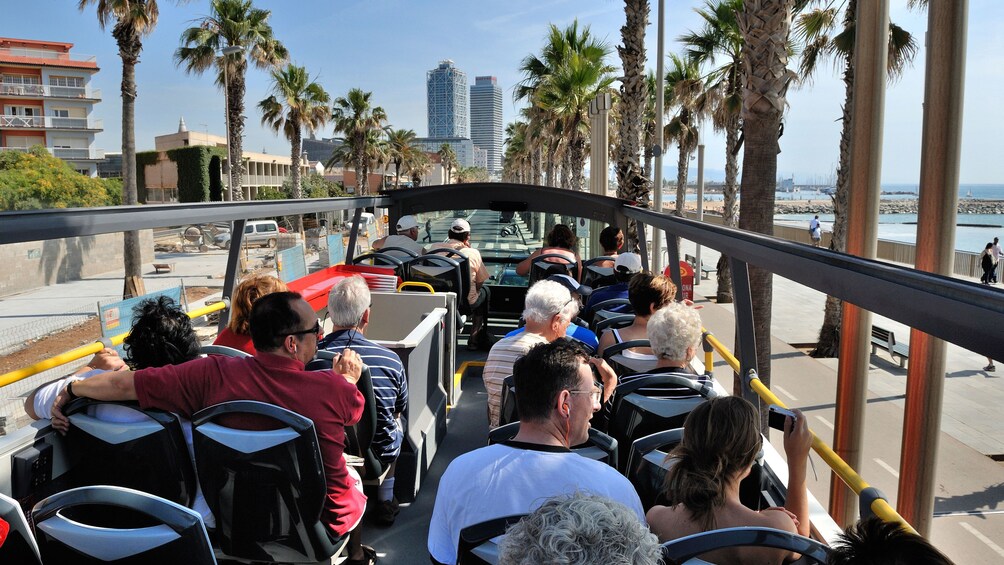 passengers on open air tour bus in Barcelona