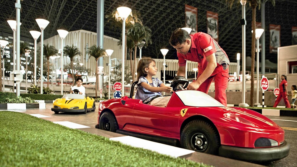 young girl driving Ferrari bumper car at Abu Dhabi Ferrari world