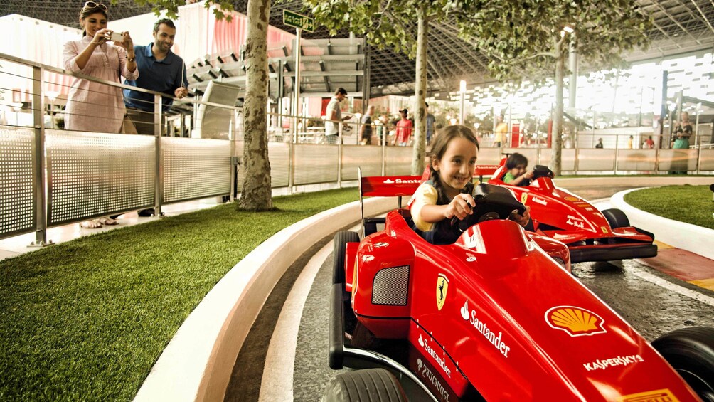 young girl racing Ferrari go-cart in Abu Dhabi Ferrari world 