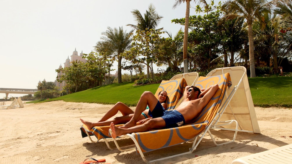 man and woman lounging in beach chairs at waterpark in Dubai