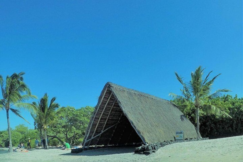 Hawaiian thatched hut at white sand beach
