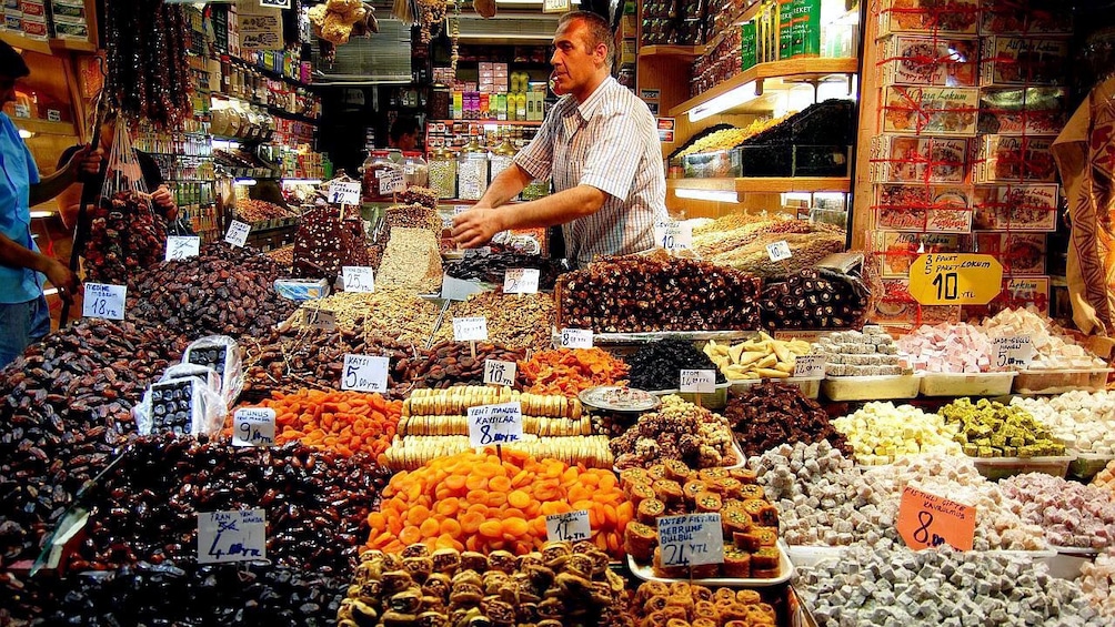 Man selling goods at a candy and sweets shop in Istanbul 