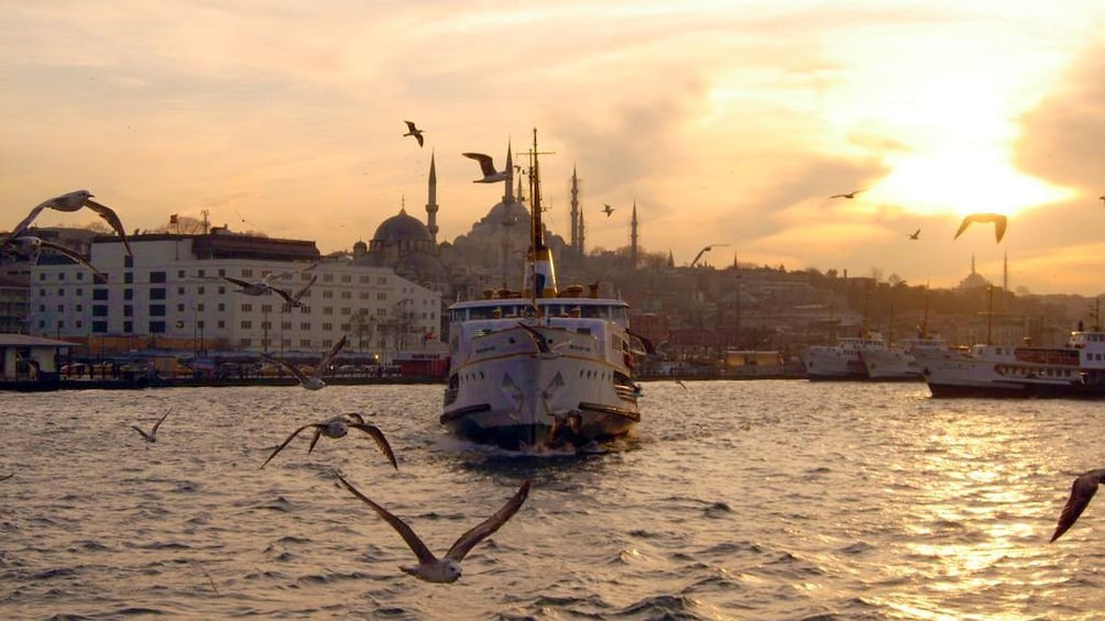 View of the Istanbul ferry going through the water during sunset