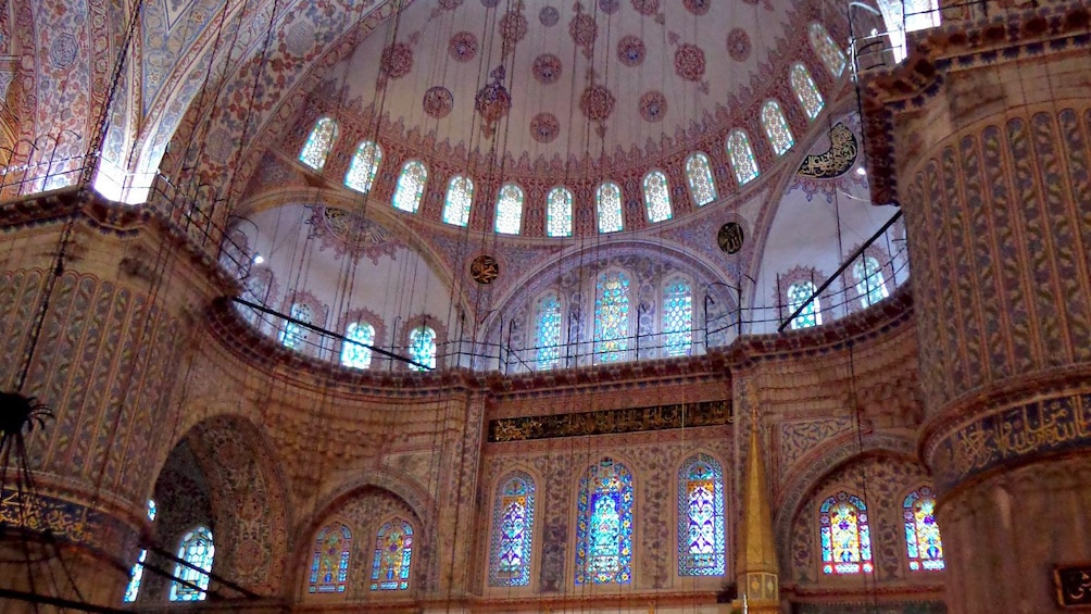 The dome inside the Blue Mosque with light shining through in Istanbul 