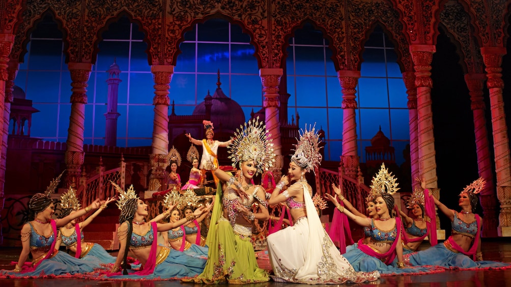 Performers in traditional costumes on stage at Tiffany's Cabaret Show in Pattaya