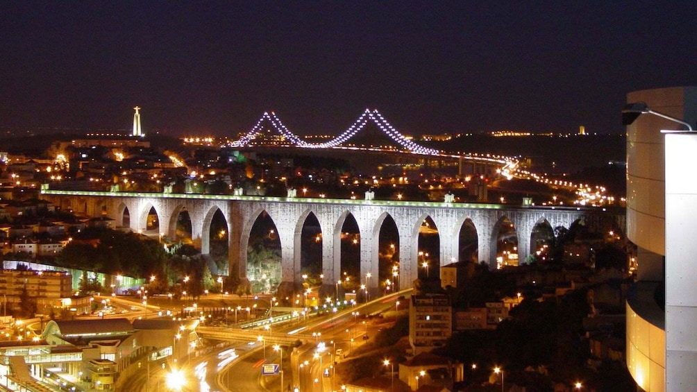 Illuminated arched bridge in Lisbon