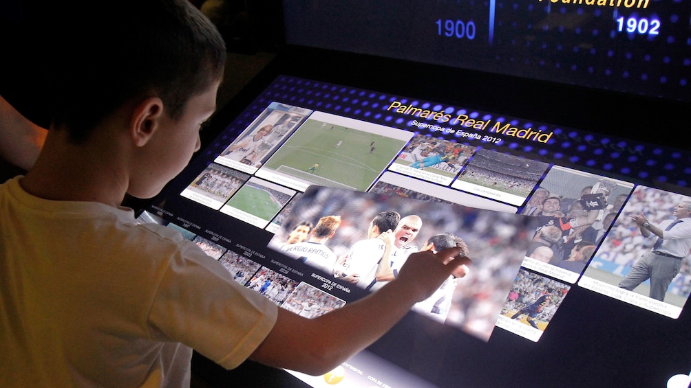 Boy looking at a display inside Bernabeu Stadium in Madrid
