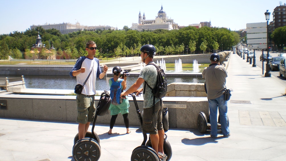 People on segways and others taking pictures in Madrid on a sunny day