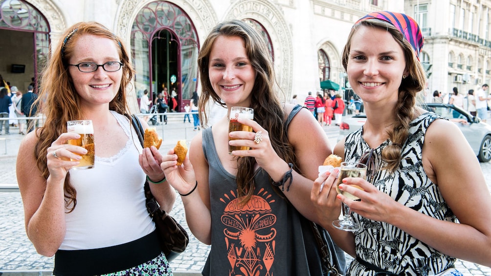 Young ladies enjoying a few pints of beer as they tour through Lisbon