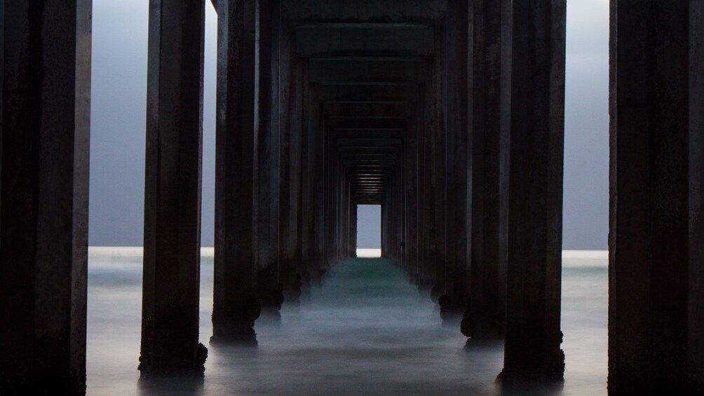 Posts under the pier on the La Jolla beach in San Diego 