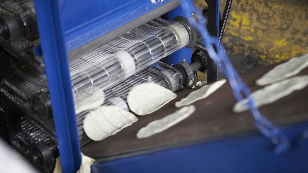 Uncooked dough entering a conveyer belt in the Tijuana up and down city tour in San Diego