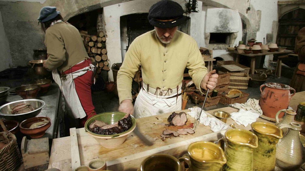 character actors prepare evening meal at Hampton Court palace in London