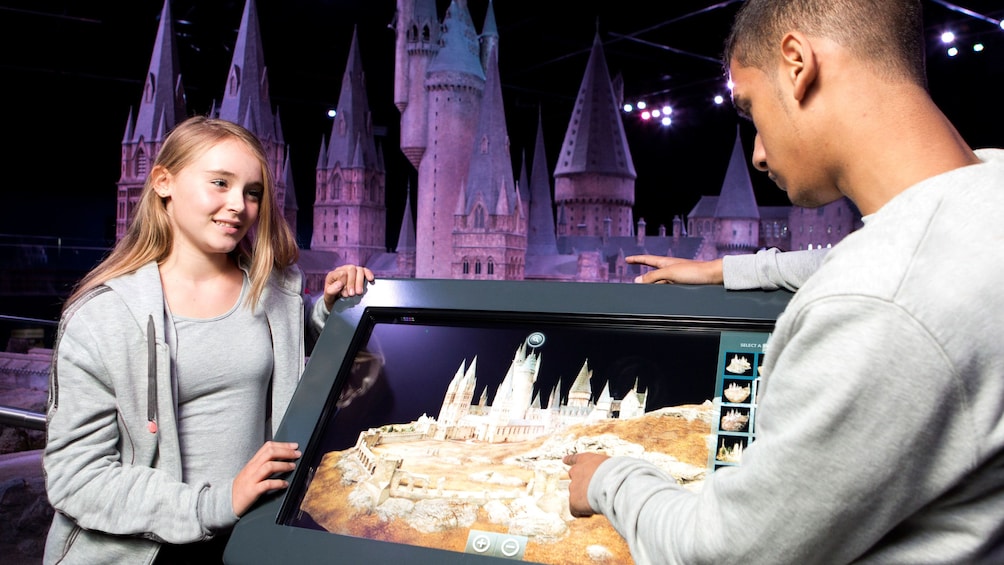 boy and girl look at interactive screen for on Harry Potter Tour in London