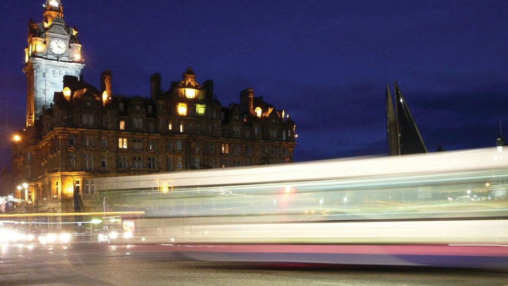 light streaks from bus at night by Westminster Abby