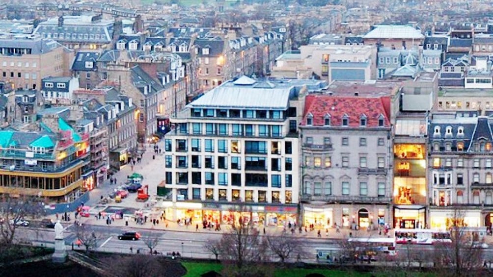 ariel photo of Edinburgh stores on city lit street 