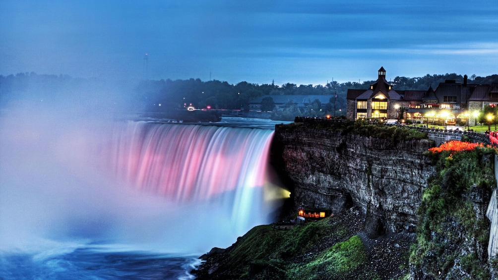 Colorfully lit waterfall in the evening at Niagara Falls