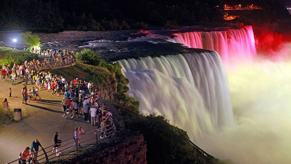 Crowd gathered at the brightly lit waterfall at Niagara Falls