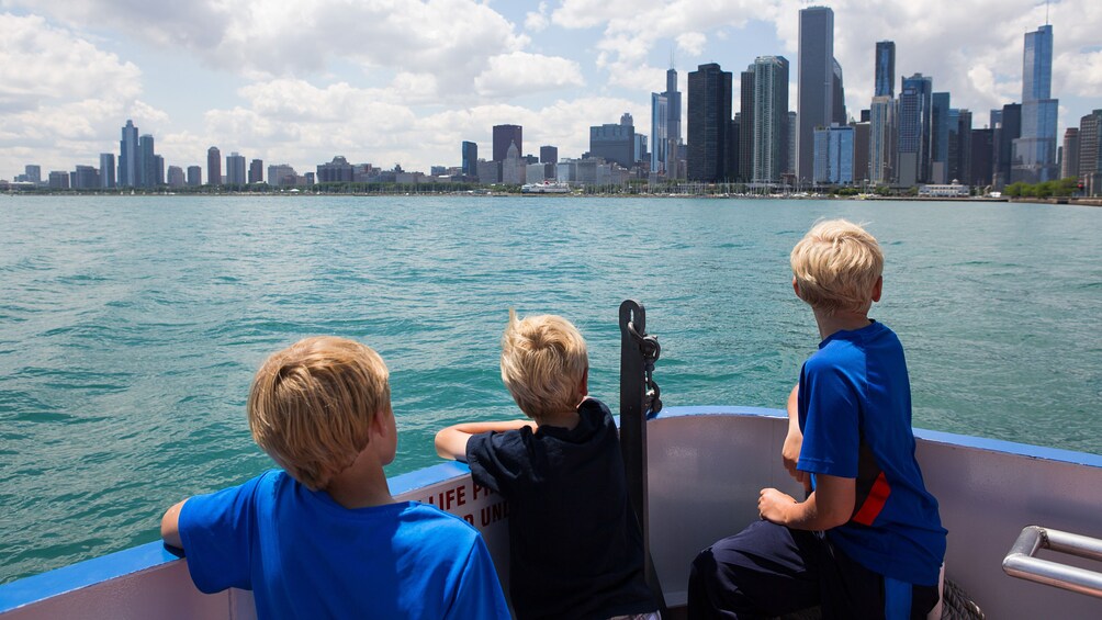 Kids on a boat looking at Chicago skyline