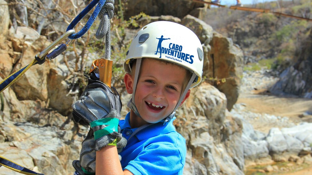 boy in climbing gear in Los Cabos