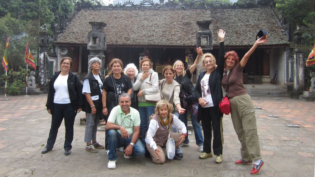 visitors posing at a temple in Vietnam