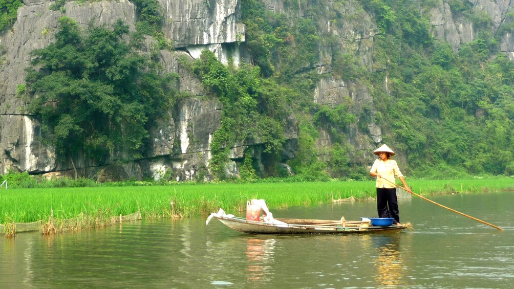 woman rowing a small raft in Vietnam