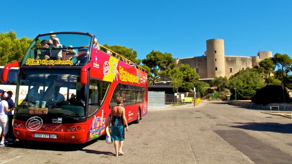 Double decker tour bus featuring an open air roof-top for guests to enjoy panoramic views of the city