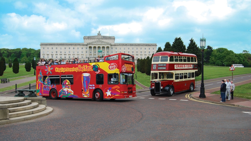 Double decker busses outside the Northern Ireland Assembly building in Belfast