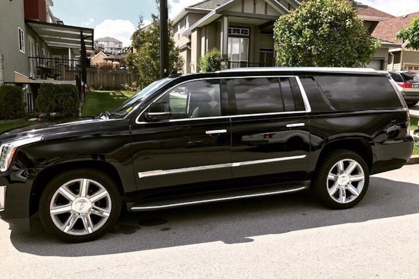 Black SUV, perfect for 4 guests with 6 suitcases and 4 carry on.