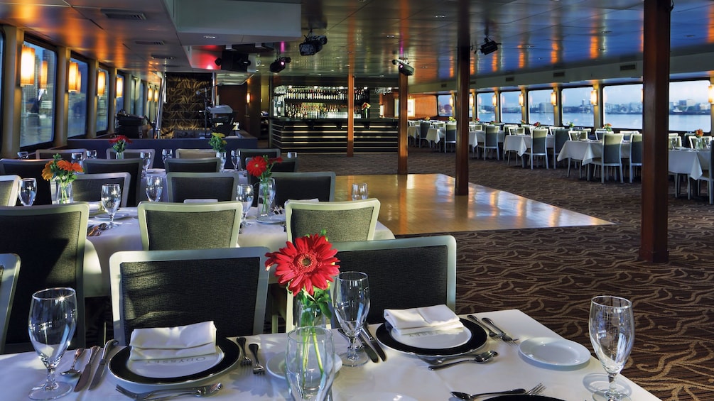 Elegantly set tables and dance floor onboard the dinner cruise ship in Boston