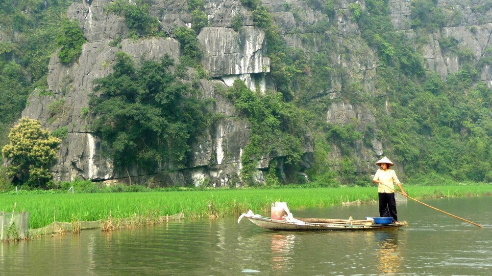woman rowing a small raft in Vietnam