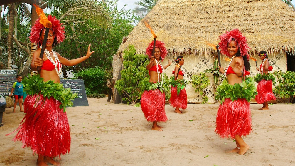 Show item 1 of 5. tribeswomen dancing with torches at Robinson Crusoe Island in Fiji